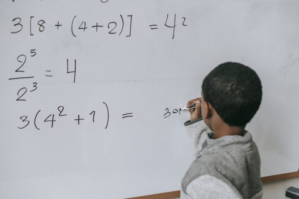 Concentrated black kid doing sums