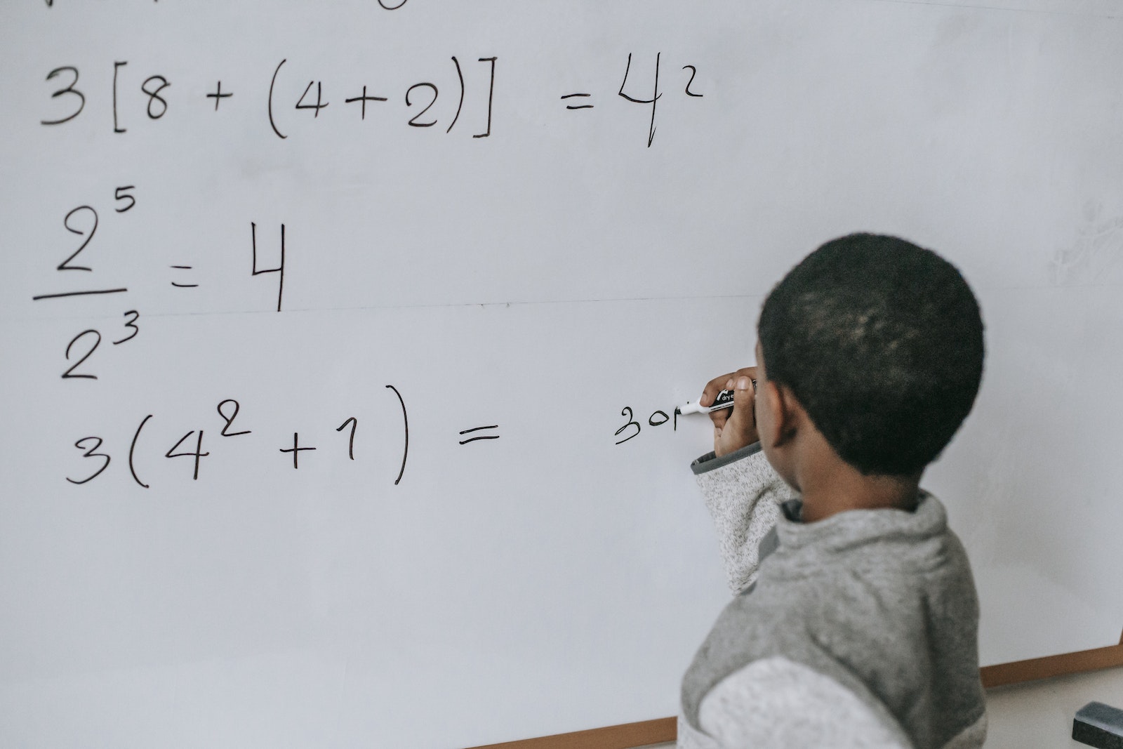 Concentrated black kid doing sums